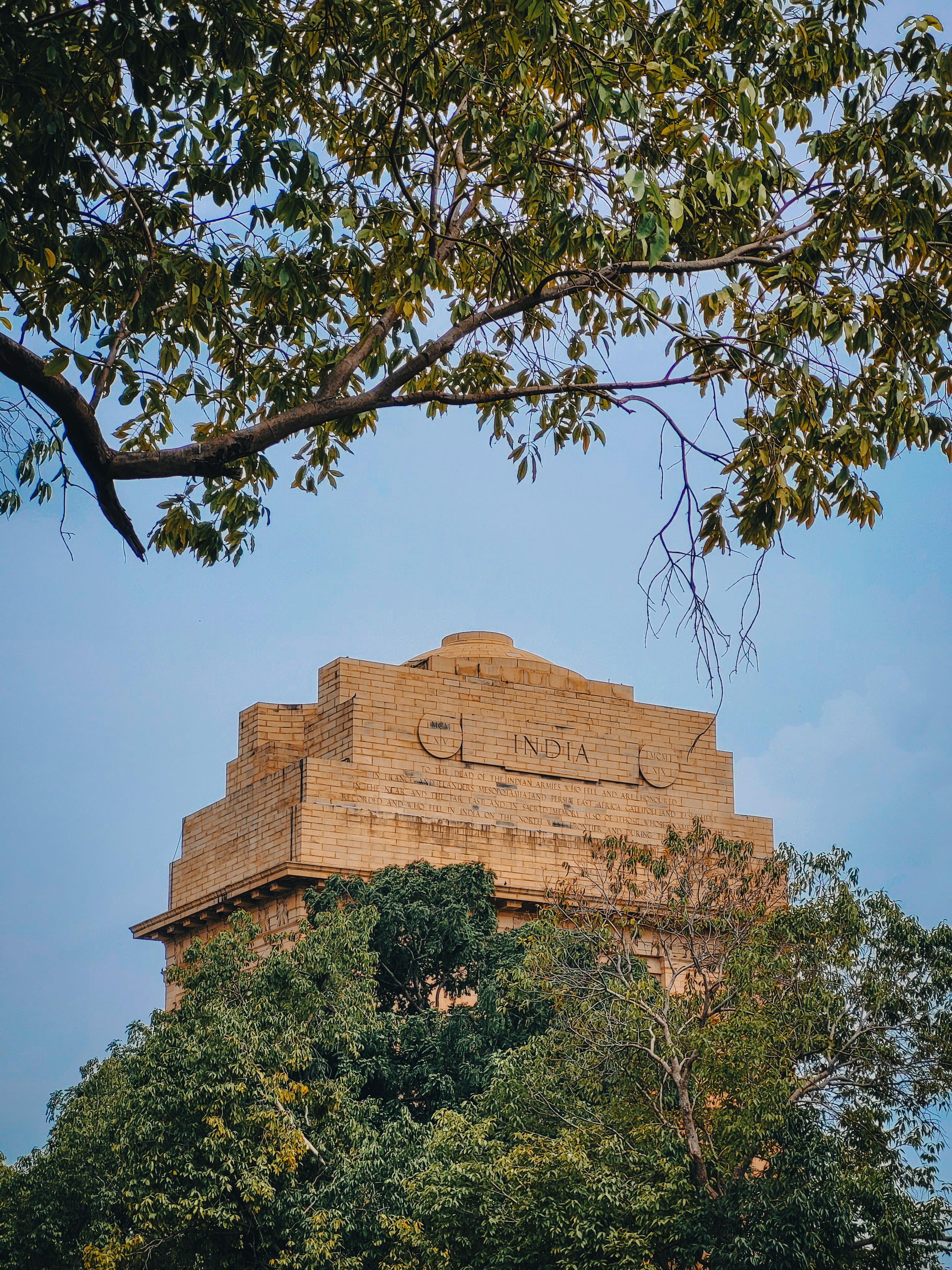 Sandstone memorial framed by trees
