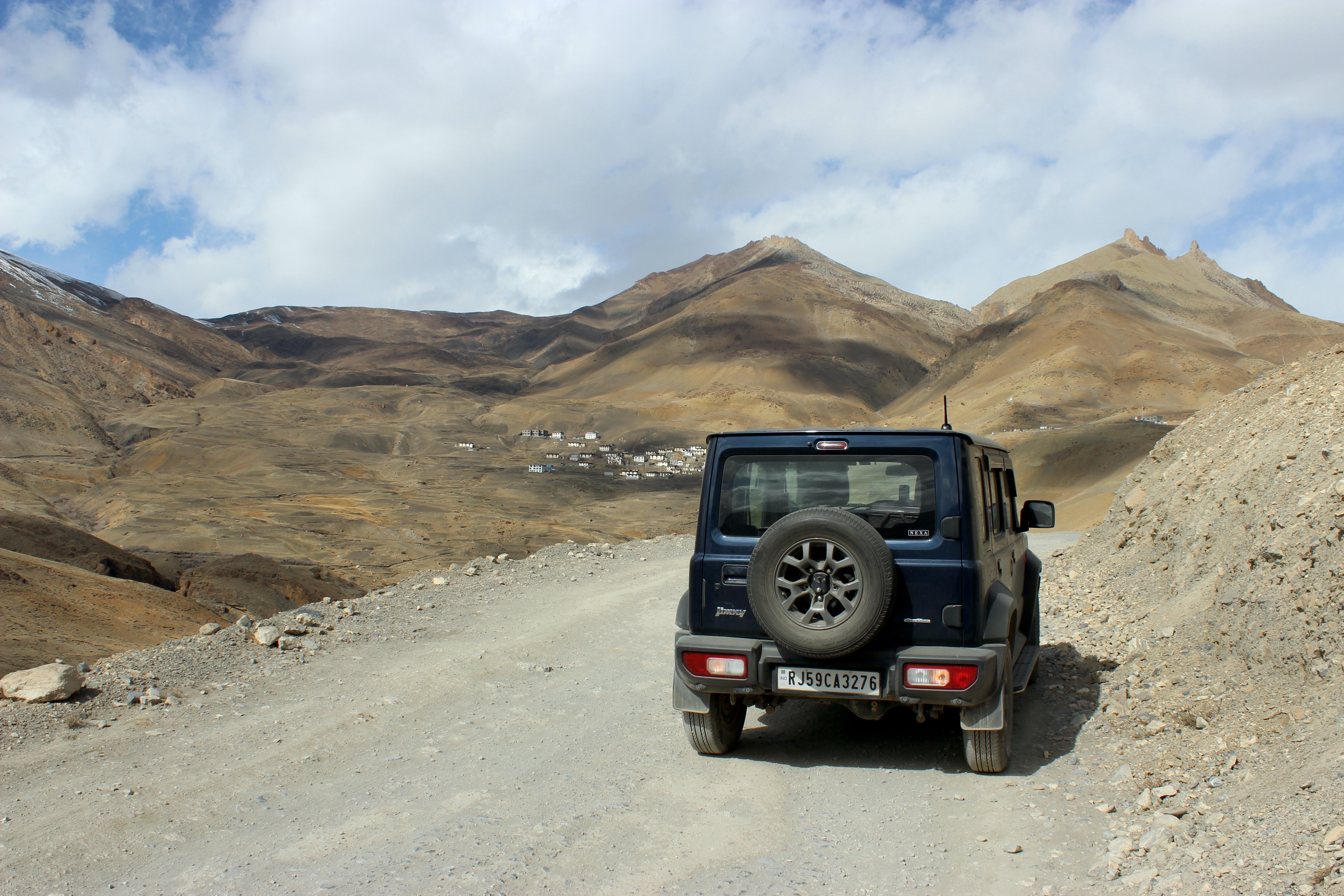 Snow-covered mountain scenery with a parked vehicle