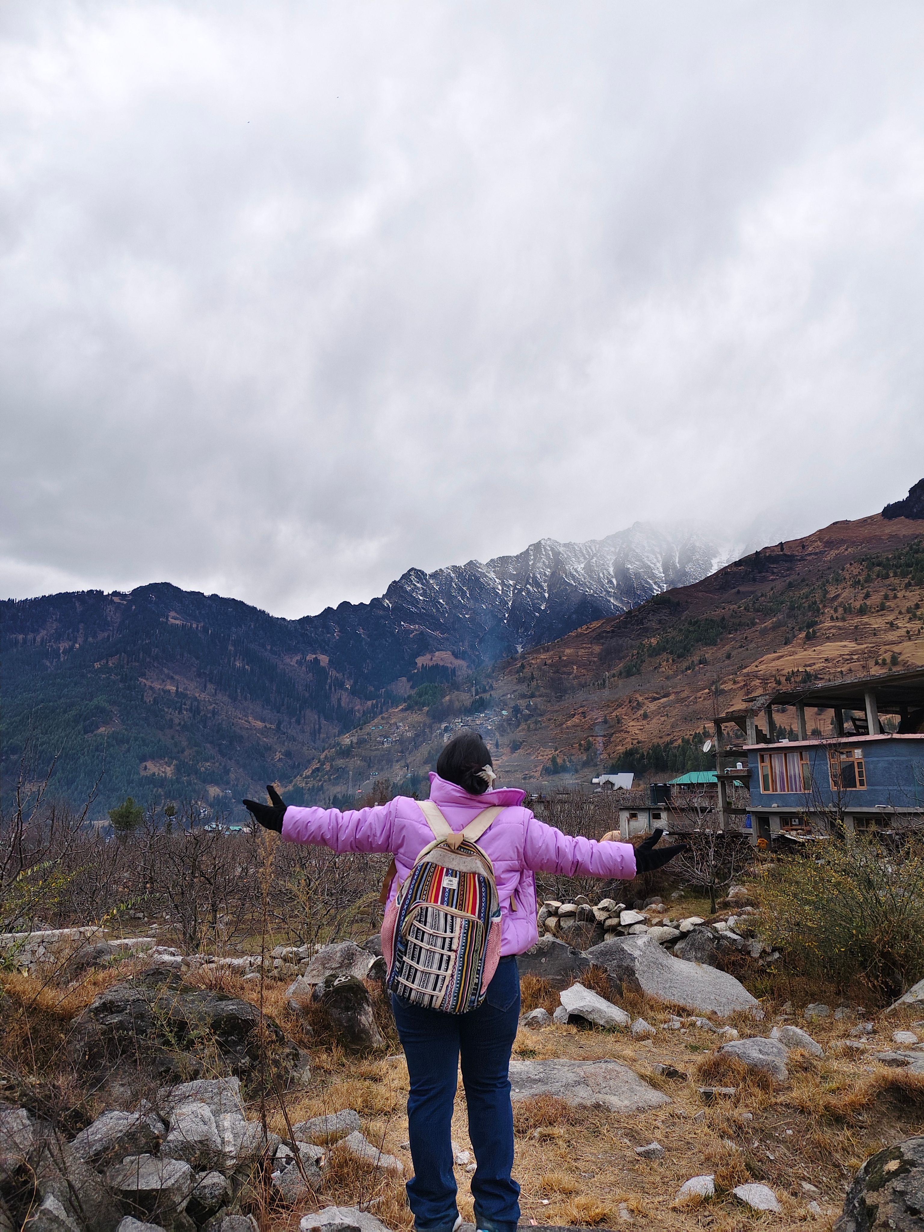 A traveller looking out across a mountain valley